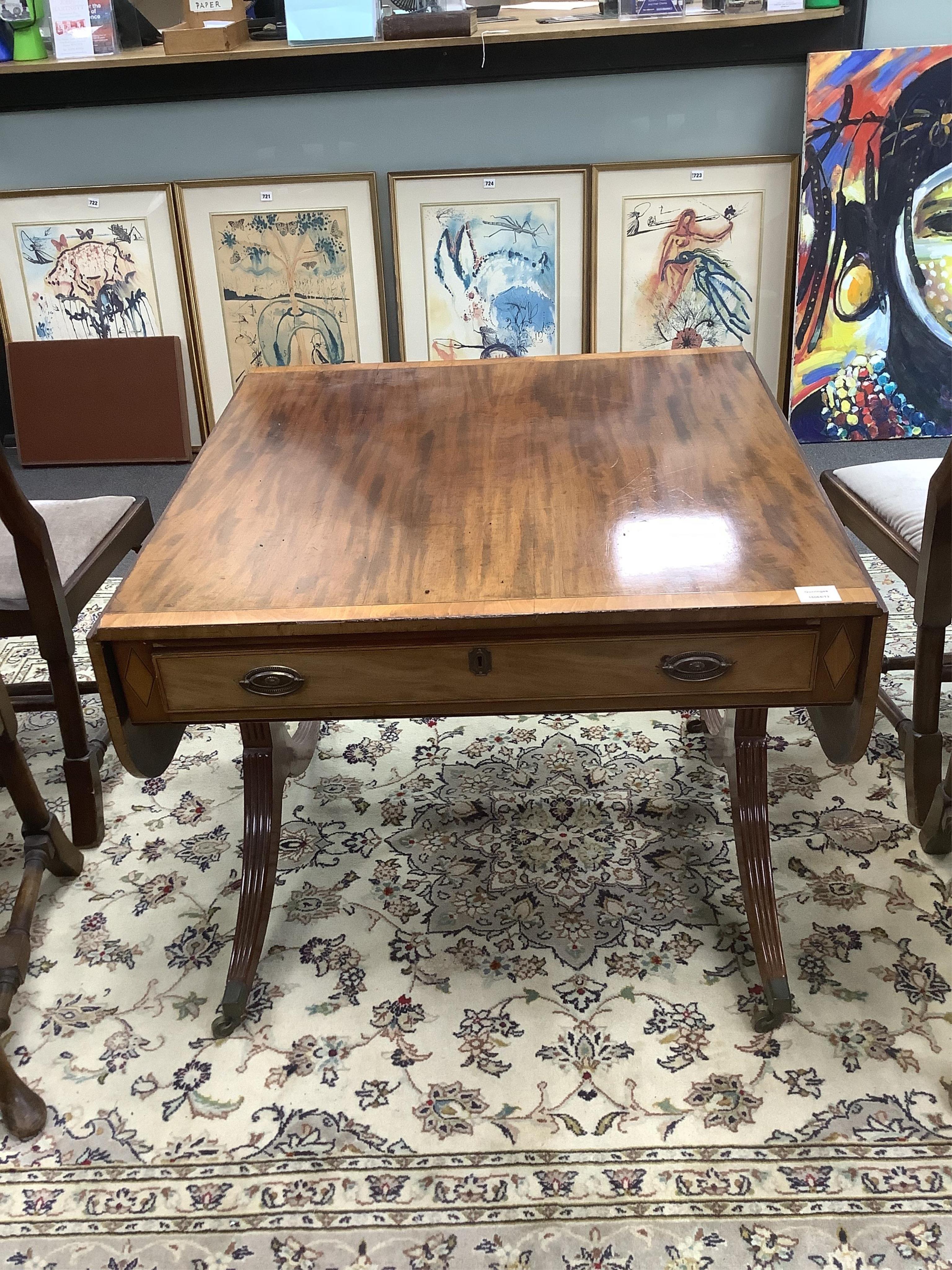 A Regency satinwood banded mahogany sofa table, width 132cm extended, depth 84cm, height 71cm. Condition - fair